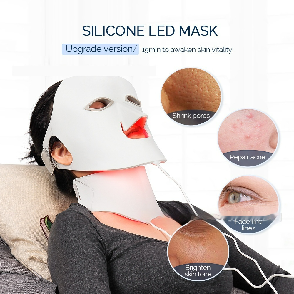 Woman relaxing while wearing the LumaGlow face and neck mask with red light on
